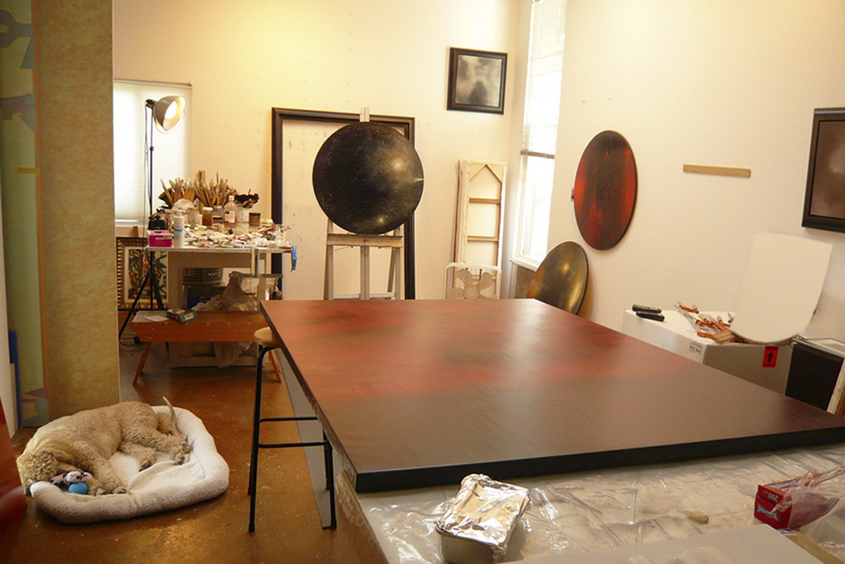An art studio filled with equipment and artworks