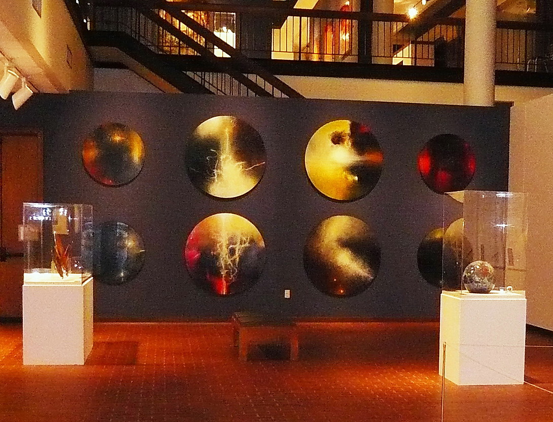 A wall of round paintings